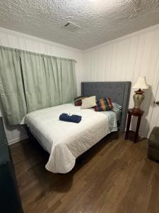a bedroom with a large bed with white sheets at April Palace green in Decatur