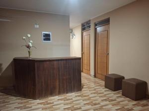 a lobby with a reception desk with a vase of flowers at Hospedaje AMAPI - San José in El Carmen