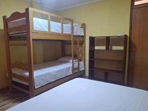 a room with two bunk beds and a bed at Hospedaje AMAPI - San José in El Carmen