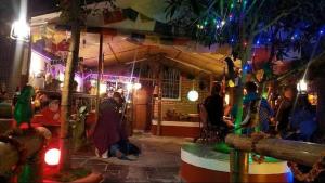 a group of people standing outside of a bar at night at Hotel The Mint Garden in Pokhara