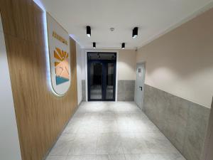 a hallway of an office building with a door and a hallwayngth at Atamura 1 in Karagandy +4 photos
