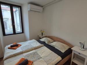 a bedroom with a bed and a window at ReginaMare Santa in Piran