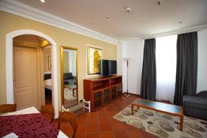 a hotel room with a bed and a mirror at Hotel Pushkin in Oral