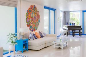 a living room with a white couch and a piano at Private Pool Party Villa games Karaoke, in Nonthaburi