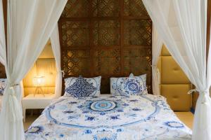 a bedroom with a blue and white bed with a canopy at Private Pool Party Villa games Karaoke, in Nonthaburi +139 photos