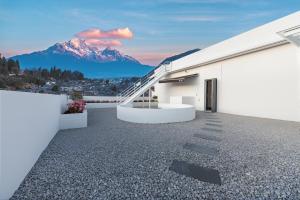 a white building with a staircase and a mountain at 熹楠丽江古城 in Lijiang