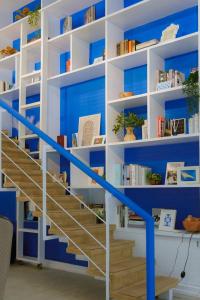a staircase with blue walls and white shelves at Private Pool Party Villa games Karaoke, in Nonthaburi