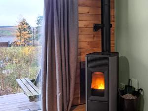 a wood stove in a room with a window at Mars 4 - Uk50474 in Greenhaugh