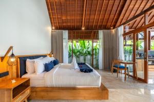 a bedroom with a bed and a table in a room at Villa Al-Mulk in Ubud +41 photos