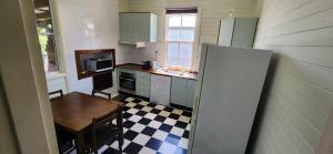 a small kitchen with a table and a refrigerator at Gloucester View in Gloucester +4 photos