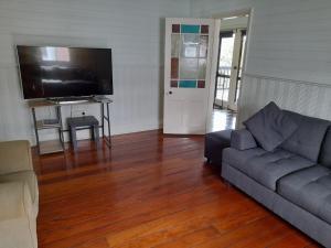 a living room with a couch and a flat screen tv at Gloucester View in Gloucester