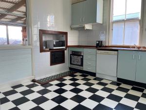 a kitchen with a black and white checkered floor at Gloucester View in Gloucester