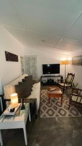 a living room with a couch and a table at LAZA villa in Nuwara Eliya