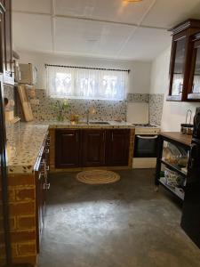 a kitchen with a sink and a window in it at LAZA villa in Nuwara Eliya