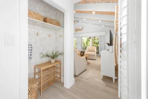 a living room with white walls and wooden floors at Wait N' Sea- Previously Millertime home in Captiva