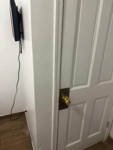 a door with a gold door knob on it at Downtown Taylor Private Entry Room 1 in Phoenix +2 photos