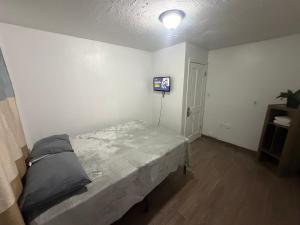 a bedroom with a bed and a light on the wall at Downtown Taylor Private Entry Room 1 in Phoenix