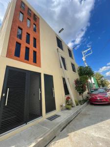 a building with a car parked in front of it at Casa Mancera Oaxaca in Yelateni