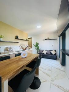 a living room with a wooden table and a couch at Casa Mancera Oaxaca in Yelateni