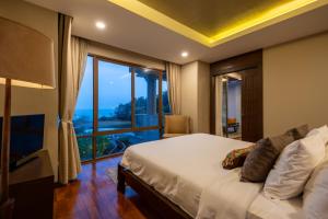 a bedroom with a bed and a large window at CasaVela 213 - 2BR apartment Seaview in Natien Beach +56 photos