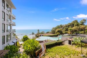 an aerial view of a resort with a swimming pool and the ocean at CasaVela 213 - 2BR apartment Seaview in Natien Beach