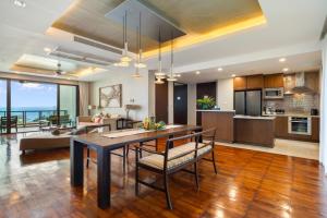 a kitchen and living room with a dining table and chairs at CasaVela 213 - 2BR apartment Seaview in Natien Beach