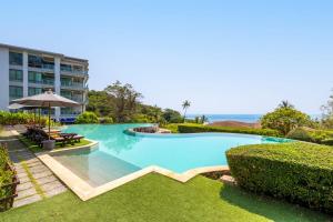 a large swimming pool in front of a building at CasaVela 213 - 2BR apartment Seaview in Natien Beach