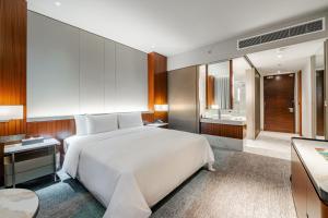 a bedroom with a large white bed and a bathroom at St Giles Mid Valley Kuala Lumpur in Kuala Lumpur +12 photos