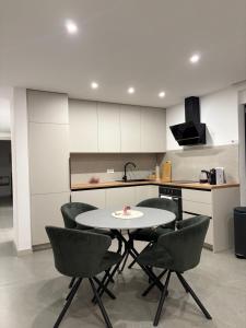 a kitchen with a table and chairs in a room at Apartment Delux in Posušje