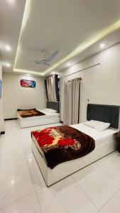 a bedroom with two beds in a room at Peace Continental Hotel in Islamabad +24 photos