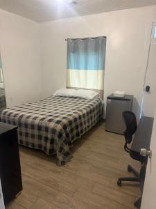 a small bedroom with a bed and a chair at Downtown Taylor Private Entry Room 2 in Phoenix