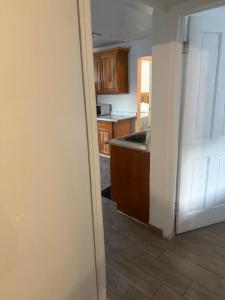 a kitchen with wooden cabinets and a counter top at Downtown Taylor Private Entry Room 2 in Phoenix +3 photos
