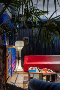 a living room with a red couch and a plant at The Benjamin House in Riga