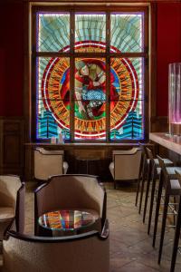 a stained glass window in a restaurant with chairs at The Benjamin House in Riga