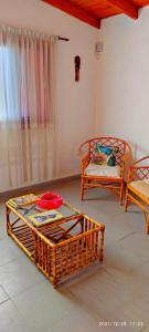 a living room with two baskets and a chair at CASA TEMPORADA 2027 PARQUEMAr in Miramar +9 photos