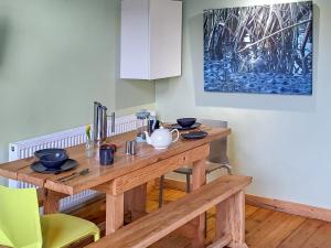 a wooden table with bowls and utensils on it at Mars 4 - Uk50474 in Greenhaugh