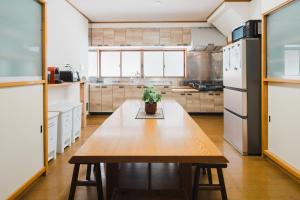 a kitchen with a wooden table with a potted plant on it at Ao No Mori in Myoko
