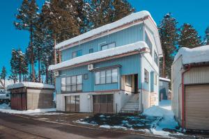 a blue and white house with snow on it at Ao No Mori in Myoko
