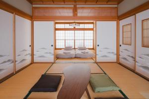 a meditation room with two beds in the middle at Ao No Mori in Myoko