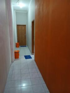an empty hallway with a door and a tile floor at K77 Backpackers - Jungle Tours in Medan +2 photos