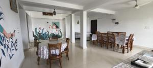 a kitchen and dining room with a table and chairs at Vagamon Hill Chimes in Vagamon