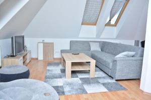 a living room with a couch and a table at Apartmá Kateřina Velké Losiny in Velké Losiny