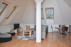 a living room with a couch and a table at Apartmá Kateřina Velké Losiny in Velké Losiny