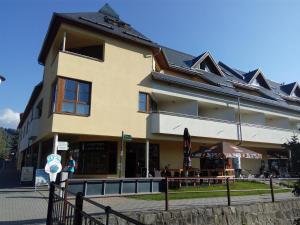 a large building with a fence in front of it at Apartmá Kateřina Velké Losiny in Velké Losiny