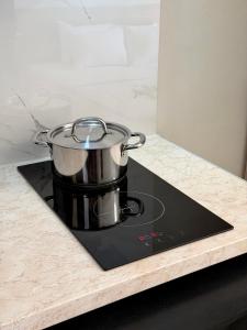 a pot sitting on top of a stove in a kitchen at Avra Yard Suites in Pefkochori
