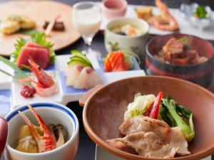 a table with a bowl of food and plates of food at Wan Wan Paradise Hamanako in Hamamatsu