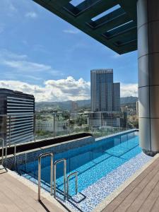 a swimming pool on the roof of a building at Hotel George in Cebu City