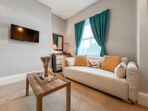 a living room with a couch and a table at The Badger Sett in Hinderwell