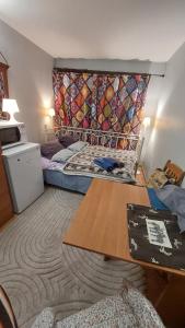 a room with two beds and a tapestry on the wall at Cosy room in Oslo