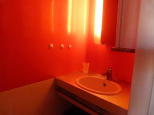 a red bathroom with a sink and a mirror at Résidence Armoise - Studio 3 personnes à Arc 1800 en centre station, proche des pistes et des commerces, dans le village des Villards MAE-1982 in Arc 1800
